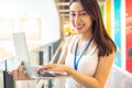 Portrait of Asian Woman Smiling Charmingly while Standing in walkway office. Portrait Of Successful Business Woman with laptop,