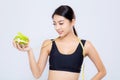 Portrait asian woman smiling holding and with measuring green apple fruit and beautiful body diet with fit isolated Royalty Free Stock Photo