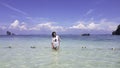 Portrait Asian woman Standing in the sea of clear skies at krabi in Thailand Royalty Free Stock Photo