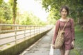 Portrait of asian woman teenage dress in casual walk with big smile on outdoor public park ,liftstyle teenage in new genaration Royalty Free Stock Photo