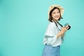 Portrait of asian woman tourist holding digital camera on green background Royalty Free Stock Photo