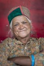 Portrait of asian woman with traditional headdress feel happy with arms crossing.