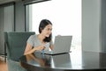 Portrait asian woman using laptop computer working on the table at home. People during the introvert time at home from the