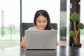 Portrait asian woman using laptop computer working on the table at home. People during the introvert time at home from the