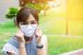 Portrait of Asian woman using surgical mask for protecting COVID-19 or epidemic disease, when go outside