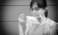 Portrait of Asian woman using surgical mask for protecting COVID-19 or epidemic disease, when go outside.. Black and white tone