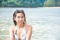 Portrait of Asian woman wearing white swimsuit and wear sunglasses lying on a sandy beach Royalty Free Stock Photo