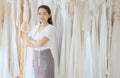 Portrait of asian woman wedding dress store owner standing and cross arm,Beautiful dressmaker in shop and small business,Happy and Royalty Free Stock Photo