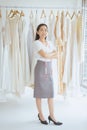 Portrait of asian woman wedding dress store owner standing and cross arm,Beautiful dressmaker in shop and small business,Happy and Royalty Free Stock Photo