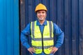 Portrait of Asian workers import and export goods wear a helmet logitics shipping at container background