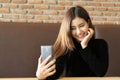 Portrait of asian young beautiful woman take selfie using smart phone camera Royalty Free Stock Photo