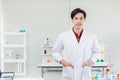 Portrait of Asian young handsome doctor scientist in hospital medical lap dressing white clean uniform looking smile