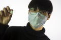 Asian young man in mask, pill in hand. Prevent spread of coronavirus Royalty Free Stock Photo