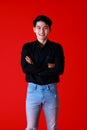 Portrait asian young man standing while folded arms crossed and looking at camera with feel confident and happy with smile on face Royalty Free Stock Photo