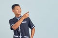 Portrait of Asian young man wearing karate uniform laughing at funny crazy joke with hands over body isolated over gray background Royalty Free Stock Photo