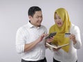 Muslim Couple Analyzing Financial Management Report