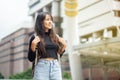 Portrait of asian young woman with backpack in the city. Royalty Free Stock Photo