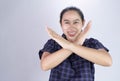 Portrait of Asian young woman in blue shirt, Show body language say no and Serious face isolated on grey background. Concept of