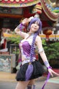 Portrait of asian young woman dancing with purple Chinese dress cosplay with temple Royalty Free Stock Photo