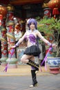 Portrait of asian young woman dancing with purple Chinese dress cosplay with temple Royalty Free Stock Photo