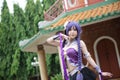 Portrait of asian young woman dancing with purple Chinese dress cosplay with temple Royalty Free Stock Photo