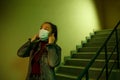 Portrait of an Asian young woman. stairwell of the hospital. the girl wears a mask to avoid getting infected with the virus