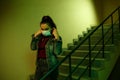 Portrait of an Asian young woman. stairwell of the hospital. the girl wears a mask to avoid getting infected with the virus