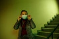 Portrait of an Asian young woman. stairwell of the hospital. the girl wears a mask to avoid getting infected with the virus