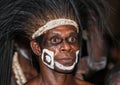 The Portrait Asmat warrior with a traditional painting and coloring on a face.