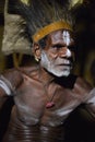 The Portrait Asmat warrior with a traditional painting and coloring on a face.