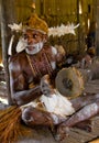 Portrait Asmat warrior with a tribal ritual drum.