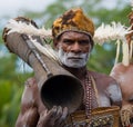 Portrait Asmat warrior with a tribal ritual drum.