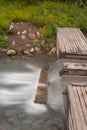 A portrait aspect of a long exposure of water tumbling down a step at the Liard Hot Springs, British Columbia, Canada