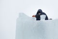 Portrait of an assembler worker in a jacket with a hood at the construction of an ice camp Royalty Free Stock Photo