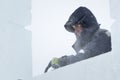 Portrait of an assembler worker in a jacket with a hood at the construction of an ice camp Royalty Free Stock Photo