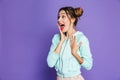 Portrait of astonished attractive woman with two buns holding ha