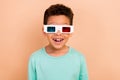 Portrait of astonished cheerful schoolkid toothy smile watch movie 3d glasses isolated on beige color background