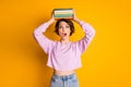 Portrait of astonished girl college student put copybooks on her head impressed how much material she need read prepare Royalty Free Stock Photo