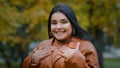 Portrait astonished hispanic happy girl receives unexpected surprise in park outdoors young enthusiastic woman rejoices