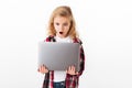 Portrait of an astonished little girl looking at laptop Royalty Free Stock Photo