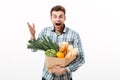 Portrait of an astonished man holding paper bag Royalty Free Stock Photo