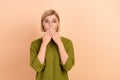 Portrait of astonished speechless girl with short hair dressed green shirt staring palms cover mouth isolated on pastel