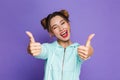 Portrait of astonished woman with two buns shouting and showing