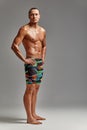 A portrait of an athlete in swimming trunks, in excellent athletic form, charismatic, adult, self-confident and charged