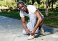 Athletic african american male in headphones before running in park Royalty Free Stock Photo