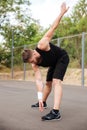 Portrait of athletic bearded man doing stretching exercises