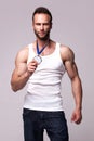 Portrait of athletic man in white undershirt with champions medal Royalty Free Stock Photo