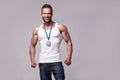Portrait of athletic man in white undershirt with champions medal Royalty Free Stock Photo