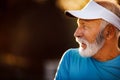 Portrait of athletic mature man after run. Handsome senior man resting after jog at the park