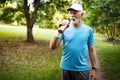 Portrait of athletic mature man after run. Handsome senior man resting after jog at the park